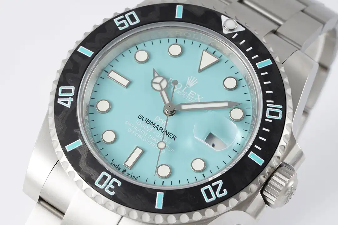 Dial and bezel at an angle, aqua graduations on a marbled black ring, crown at three