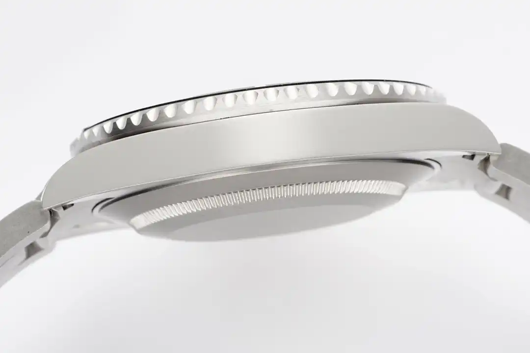 Nine side profile, coin-edge trim over a satin case band, bracelet end link at right
