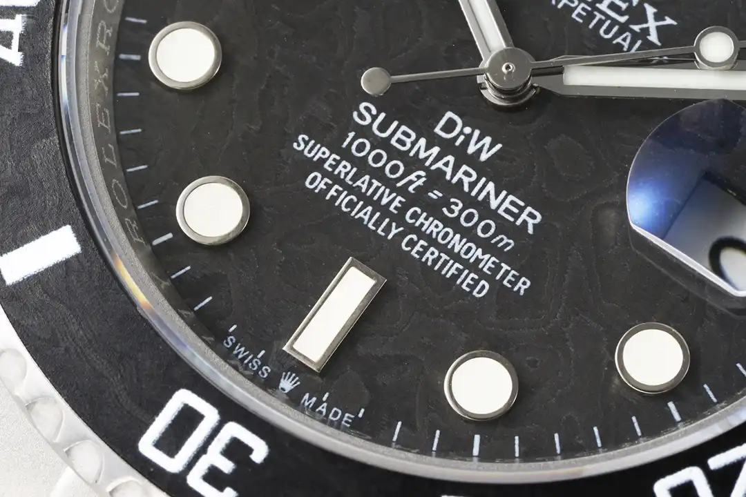 Dial close-up, round and baton markers on marbled dark grain, DiW Submariner printing below centre