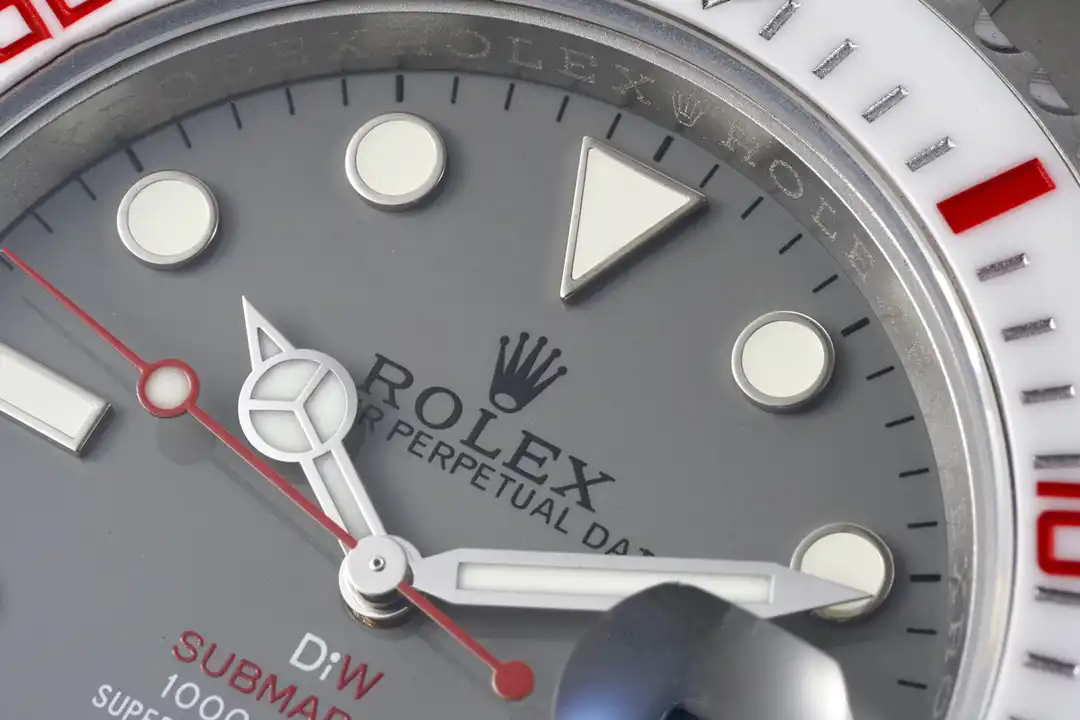Dial close-up, round lume plots with a triangle at twelve on matte grey