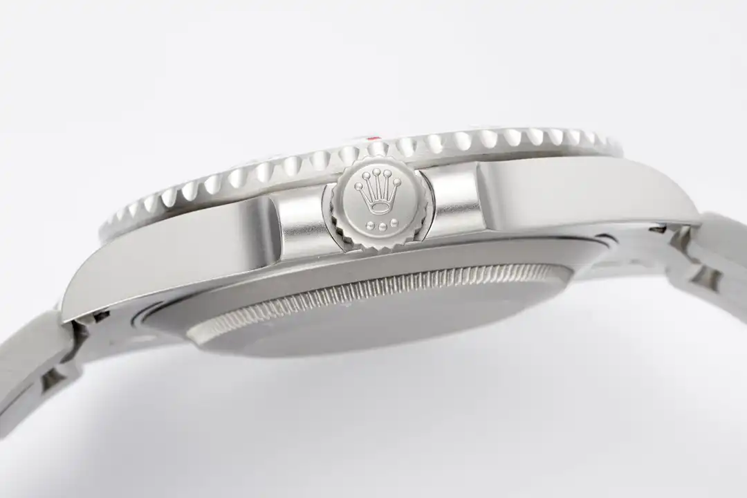 Screw-down crown between its guards, bezel serration running along the flank