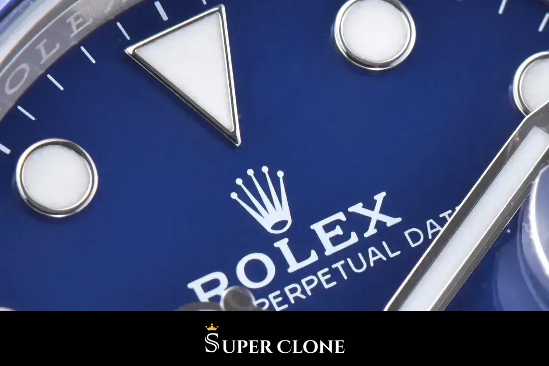 Triangle marker at 12, coronet and brand text over deep blue, round plots either side