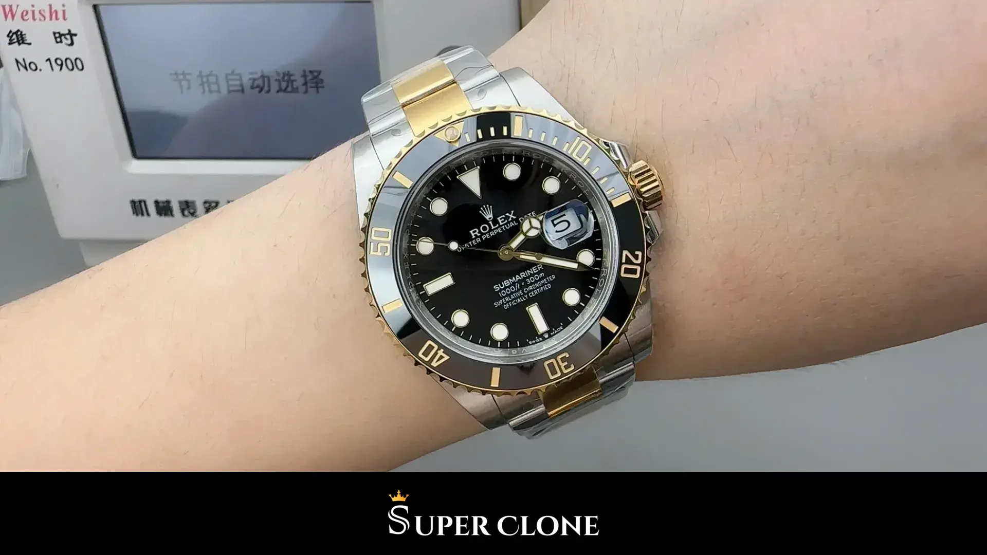 Watch on the wrist, black dial legible in flat indoor light, date reading five
