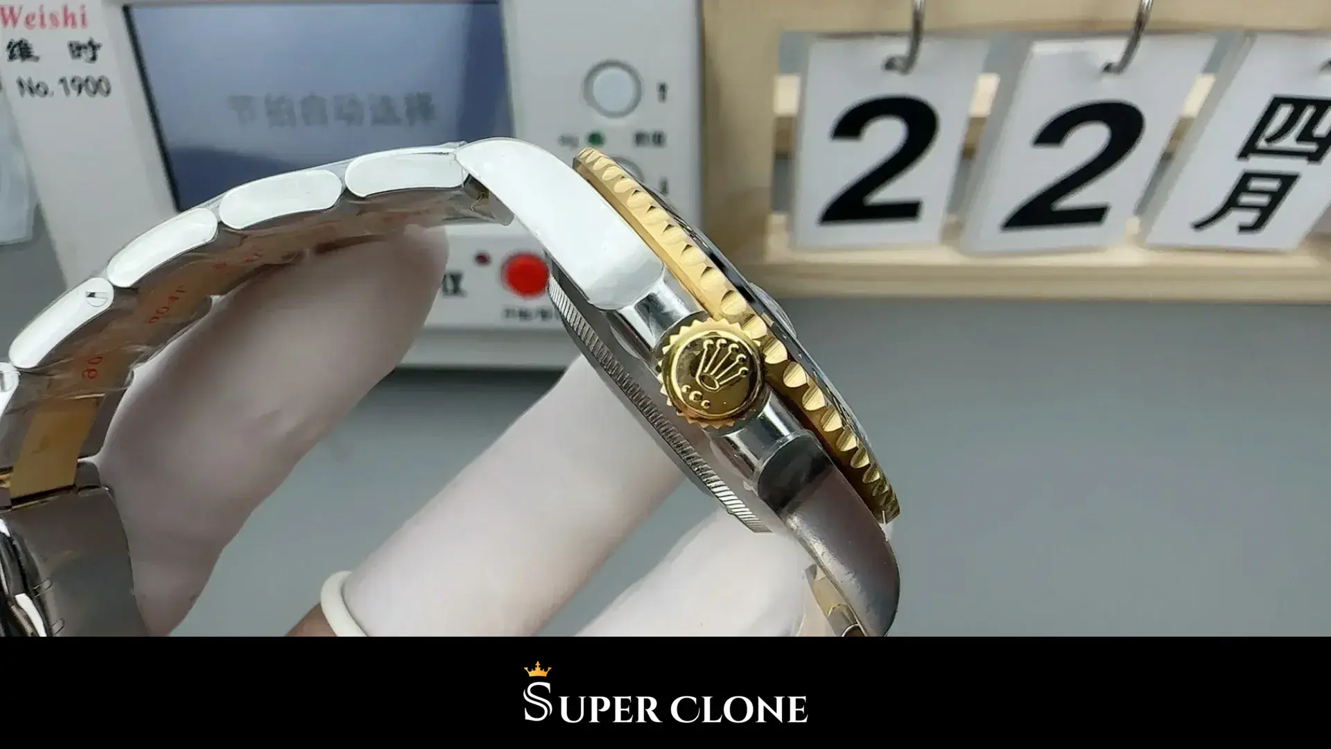Fluted crown at three in gold-tone, bezel edge and case flank alongside