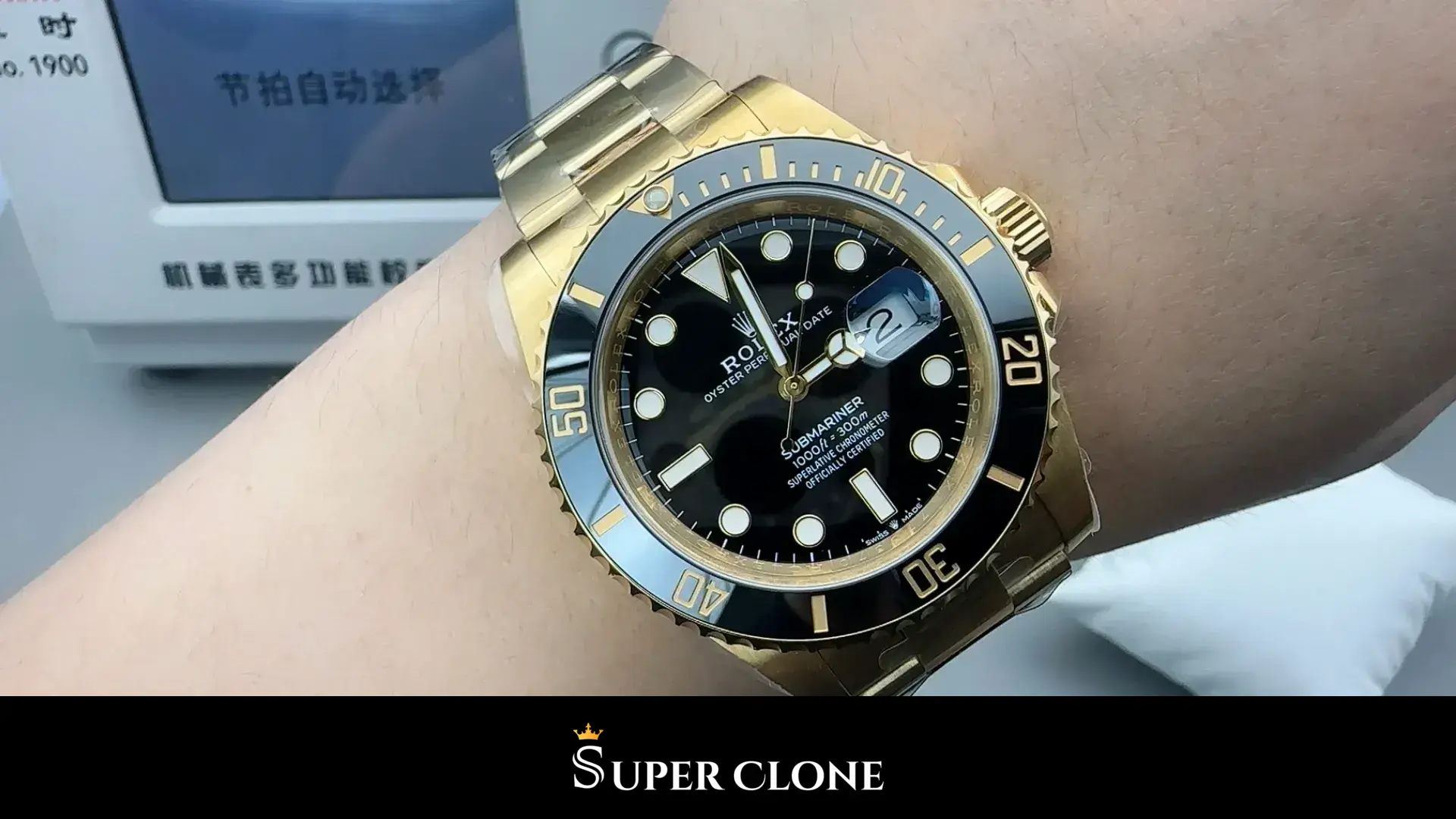 Worn on the wrist, dark bezel and polished links, date magnified at three