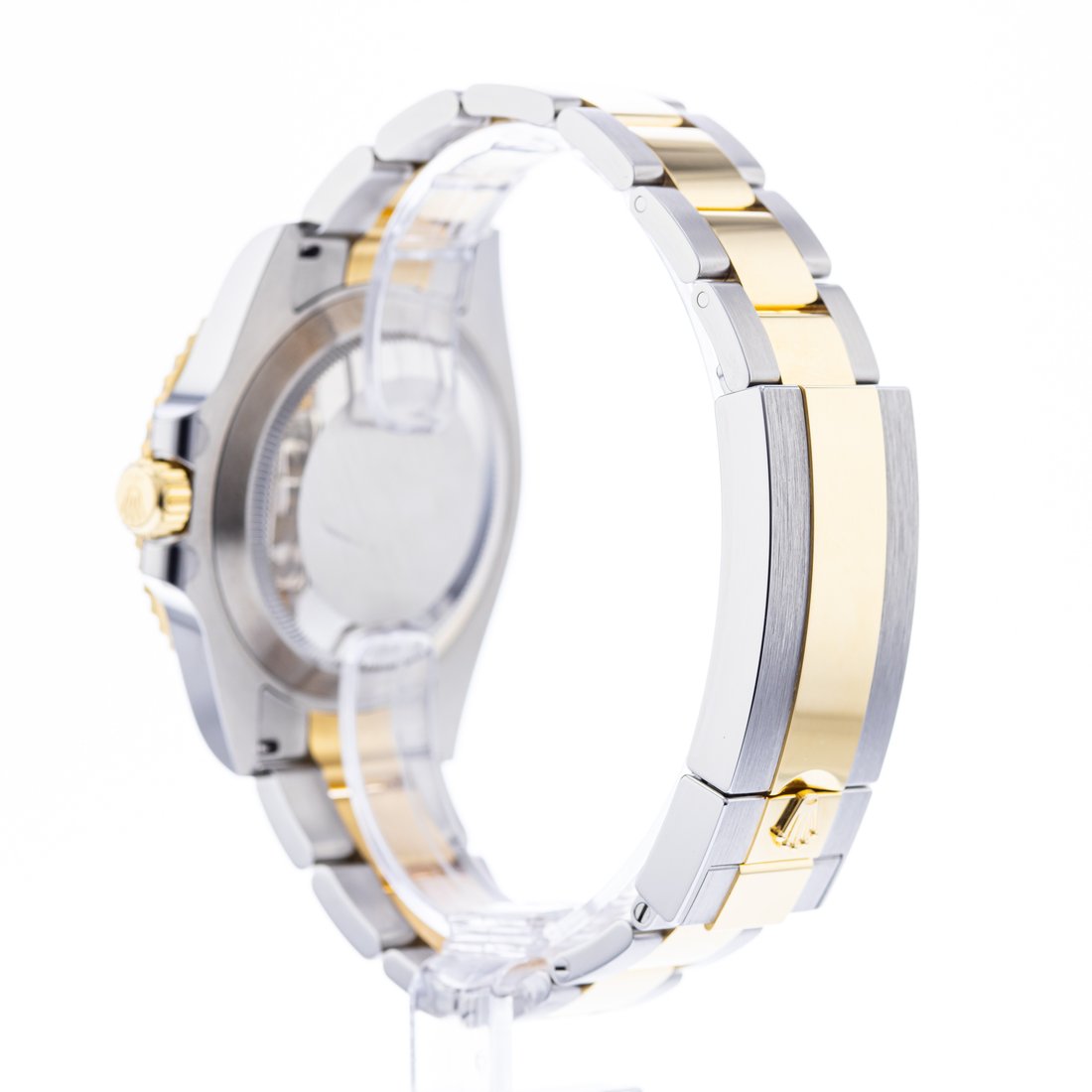 Reverse angle, plain brushed caseback beside a folding clasp cover, coronet stamped on it