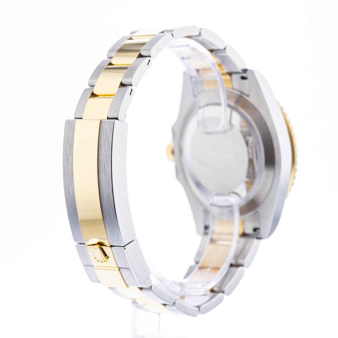 Opposite flank, Oyster links stepping toward the case, bezel edge catching a highlight