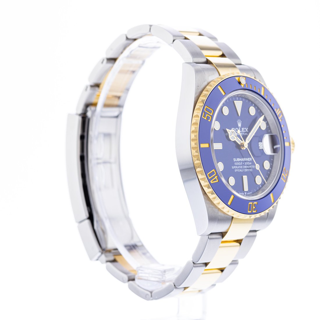 Half-turned on the stand, bezel numerals and a slice of the face still legible, links looping left